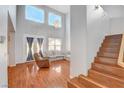 Spacious living room with high ceilings, large windows, hardwood floors and a comfortable seating area at 5642 Breckenridge St, North Las Vegas, NV 89081