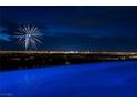 Infinity pool reflecting vibrant city lights at night, offering a serene and luxurious experience at 621 Majestic Rim Dr, Henderson, NV 89012