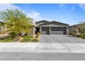 Charming single-story home with a spacious two-car garage and a beautifully landscaped front yard in a residential neighborhood at 6270 Lamont Hills Ave, Las Vegas, NV 89139