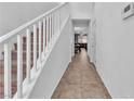Bright hallway with staircase leading to a spacious living area, creating an open and airy atmosphere at 6379 Dundock Ave, Las Vegas, NV 89122