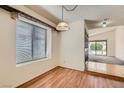 Dining area with wood floors, a stylish light fixture, and a view into the living room at 6417 Plumcrest Rd, Las Vegas, NV 89108