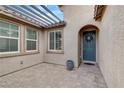 Inviting entryway with a paver patio, pergola, and a stylish blue front door at 6814 Willowcroft St, Las Vegas, NV 89149