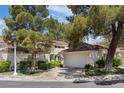 Charming two-story home with a tile roof, well-maintained landscaping, and attached two-car garage at 6925 Emerald Springs Ln, Las Vegas, NV 89113