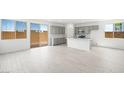 Bright, open kitchen with stainless steel appliances, white counters, and light gray cabinets at 77 Tardando Ave, Henderson, NV 89015