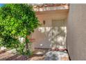 A secure front entryway with a decorative security door, complemented by lush greenery at 7721 Sour Gum Ct, Las Vegas, NV 89131