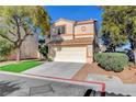 Attractive two-story house with neat landscaping, mature trees, and a two-car garage at 7721 Sour Gum Ct, Las Vegas, NV 89131