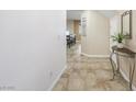 Spacious tiled entry way with table and plant, leading to dining area at 7916 Nesting Pine Pl, Las Vegas, NV 89143