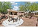Inviting backyard features a cozy fire pit area and desert landscaping, perfect for relaxing outdoors at 8316 Imperial Lakes St, Las Vegas, NV 89131