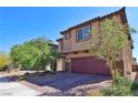 Attractive two-story home featuring a tile roof, brick paved driveway, and desert landscaping at 8324 S Miller Ln, Las Vegas, NV 89113
