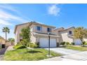 Exterior elevation with lawn and desert landscaping in front of a two story home at 9013 Meisenheimer Ave, Las Vegas, NV 89143