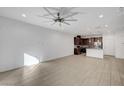 Spacious living room with tile flooring, modern lighting, and an open layout at 985 Via Lombardi Ave, Henderson, NV 89011