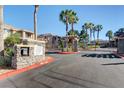 Gated community entrance with stone pillars, a map display, and well-maintained landscaping at 9901 Trailwood Dr # 2109, Las Vegas, NV 89134