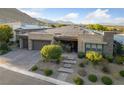 Stunning single-story home featuring a stone facade, solar panels, three-car garage, and professionally landscaped front yard at 10084 Terrastone Dr, Las Vegas, NV 89148