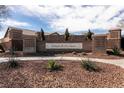 Highgate at Providence community entrance featuring brick design and manicured desert landscaping at 10417 Artful Stone Ave, Las Vegas, NV 89149