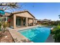 Inviting pool with covered patio, perfect for outdoor relaxation and entertaining at 10417 Artful Stone Ave, Las Vegas, NV 89149