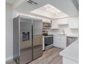 Modern kitchen with stainless steel appliances, white cabinets, and a skylight at 1201 Sulphur Springs Ln # 101, Las Vegas, NV 89128