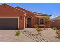 Charming single-story home with desert landscaping, brick-paved driveway, and a two-car garage at 1424 Pin Cushion Rdg, Mesquite, NV 89034