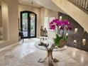 Welcoming foyer featuring a decorative table, tiled floors, wine storage, and a modern chandelier at 17 Grand Corniche Dr, Henderson, NV 89011