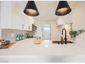 Stylish kitchen with stainless steel appliances, quartz countertops, and pendant lights at 1800 Edmond St # 115, Las Vegas, NV 89146