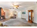 Open living room with brick fireplace, plush carpet, and natural light at 1904 Fontenelle St, Las Vegas, NV 89102