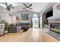 Bright living room featuring a fireplace, hardwood floors, and a ceiling fan at 224 Silver Castle St, Las Vegas, NV 89144