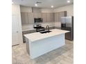 Modern kitchen with stainless steel appliances, a large island, and quartz countertops at 2444 Padulle Pl, Henderson, NV 89044