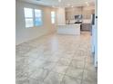 Open-concept living room featuring tile floors and abundant natural light at 2444 Padulle Pl, Henderson, NV 89044