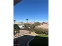 Scenic backyard view overlooking a neighborhood with palm trees and mountain views on the horizon at 2576 Chasma Dr, Henderson, NV 89044