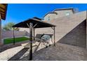 Backyard featuring gazebo over patio. Small artificial turf grass area at 2796 Sipe Springs St, Las Vegas, NV 89142