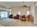 Open-concept living area features a dining area, tile flooring, and access to backyard via glass sliding door at 2805 Rungsted St, Las Vegas, NV 89142