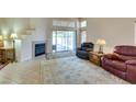 Bright living room featuring a fireplace, tile floors, and a sliding glass door to the backyard at 2805 Rungsted St, Las Vegas, NV 89142