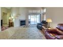 Inviting living room showcases tile floors, fireplace, and access to outdoor patio through glass slider at 2805 Rungsted St, Las Vegas, NV 89142