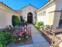 Inviting front entryway with manicured landscaping and a cozy outdoor seating area at 2809 Winslow Springs Dr, Henderson, NV 89052