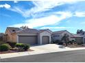Spacious single-story home featuring a tile roof, stucco walls, desert landscaping, and a convenient three-car garage at 2809 Winslow Springs Dr, Henderson, NV 89052