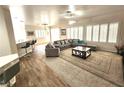 Spacious living room with a large gray sectional, shutters, and modern decor, creating a welcoming atmosphere at 2809 Winslow Springs Dr, Henderson, NV 89052