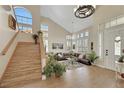 Grand foyer with vaulted ceiling, wood staircase, and views of the spacious living area at 2909 Sterling Cove Dr, Las Vegas, NV 89128