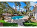 Backyard pool featuring mature palms, spa, and ample space for entertaining and relaxing at 2909 Sterling Cove Dr, Las Vegas, NV 89128
