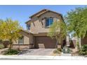 Inviting two-story home featuring a front-facing two-car garage and low maintenance desert landscaping at 2951 Overlook Brook St, Las Vegas, NV 89156