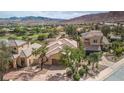 An aerial shot showcasing the property's prime location on a lush green golf course with stunning mountain views at 32 Cerchio Basso, Henderson, NV 89011