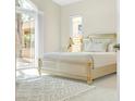 Bright bedroom with a designer bed, a patterned rug, and natural light streaming in through a large window at 32 Cerchio Basso, Henderson, NV 89011