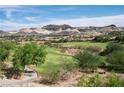Picturesque view of the golf course, showcasing its well-maintained greens and the stunning mountain backdrop at 32 Cerchio Basso, Henderson, NV 89011