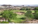 Scenic golf course view with lush green fairways surrounded by desert vegetation and distant mountains at 32 Cerchio Basso, Henderson, NV 89011