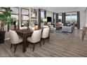 Open-concept living room and dining area with hardwood floors and large windows at 3434 Oristano Ln, Henderson, NV 89044