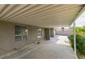 Attached carport providing covered parking and protection from the elements, with a view to the backyard at 4393 Swandale Ave, Las Vegas, NV 89121