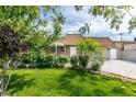 Inviting single-story home featuring lush landscaping, a well-manicured lawn, and a classic design at 4393 Swandale Ave, Las Vegas, NV 89121