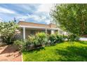 Charming single-story home boasts a lush front yard with mature plants, enhancing curb appeal at 4393 Swandale Ave, Las Vegas, NV 89121