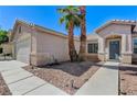 Front entrance of a single Gathering home with rock landscaping and a concrete walkway at 444 Flores Cir, Las Vegas, NV 89123