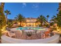 Inviting backyard featuring a large pool with a surrounding patio and lush landscaping, perfect for outdoor entertaining at 4471 Borrego Springs Way, Las Vegas, NV 89129