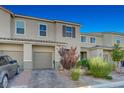 Inviting townhome showcasing a neat lawn, brick driveway, and ample parking, enhancing its overall appeal and functionality at 5269 Silver Branch Ave, Las Vegas, NV 89118