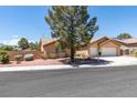 Charming single-story home featuring a well-maintained front yard with mature tree and a two-car garage at 5405 Lucky Clover St, Las Vegas, NV 89149